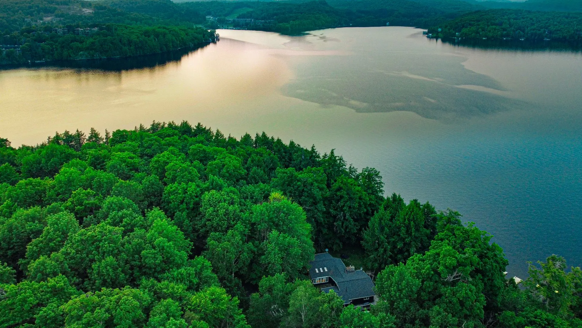 Aerial view of a lakeside home nestled among forests in Ontario's cottage country